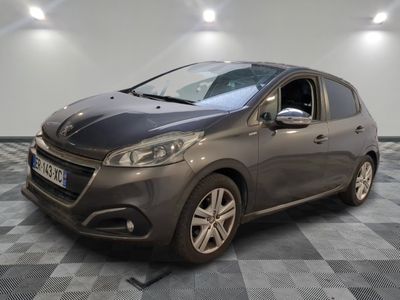 the grey car is parked on a checkered tile floor