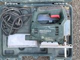 a tool in a case that is sitting on the ground