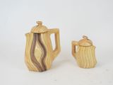 a wooden tea pot and a wooden teapot on a white background