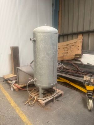a large metal tank sitting on a pallet in a warehouse