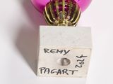 a pink ornament with a gold crown on top of it