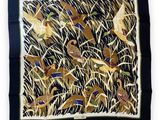 a square scarf with birds and grass on it