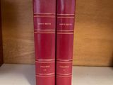 two red books on a shelf next to each other