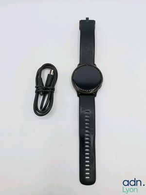 the watch is next to a charger and a charger