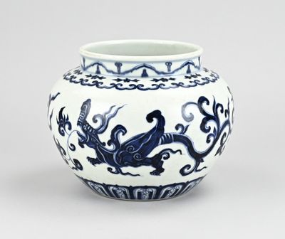 a blue and white vase with a dragon on it