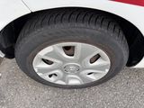 a close up of a tire on a white car