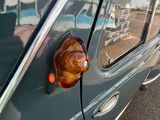 a close up of a car with a reflection of a building in the window
