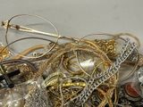 a pile of gold and silver jewelry on a table