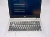 an open laptop computer sitting on top of a white table