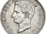 Gros plan sur une pièce de monnaie portant le visage d'un homme