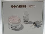 the box is open to show the contents of a skin care product