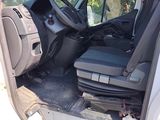 the interior of a van with the door open and the driver ' s seat down