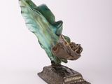 statue of a fish on a base on a white background