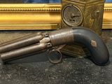 un pistolet posé sur une table à côté d'une horloge