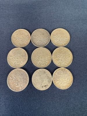 a close up of a bunch of coins sitting on top of a blue surface