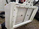a white machine that is sitting on the ground