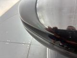 a reflection of a person in a mirror on the side of a building
