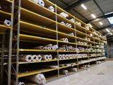 many rolls of toilet paper on the shelves in the warehouse