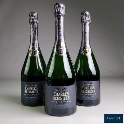 three bottles of champagne sitting next to each other on a table