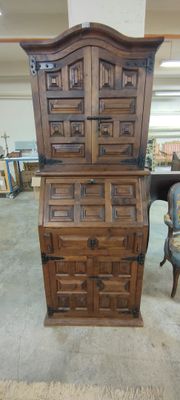 a wooden cabinet with drawers and a chair in a room