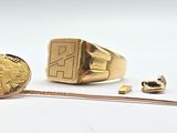 a gold ring with a gold coin next to it