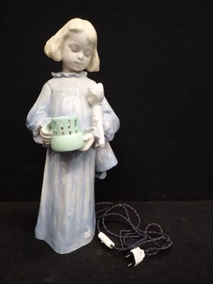 a figurine of a little girl holding a bowl