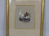painting of a vase of flowers in a gold frame on a white wall