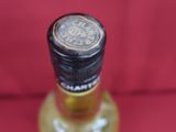 the bottle is empty on a red surface