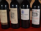 three bottles of red wine are lined up on a table