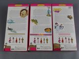 three barbie dolls are sitting on a table in front of a book