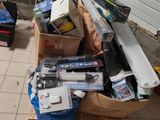 un tas d'appareils électroniques posé par terre à côté de la porte du garage