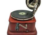 a red suitcase with a record player on top of it