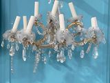 a chandelier that is hanging from a blue wall