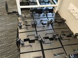 a lot of black and white pieces of luggage on the floor