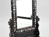 black and white wooden mirror with floral design on stand