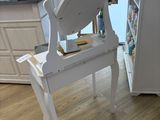 a white chair with a mirror on it in a kitchen