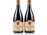 two bottles of wine sitting next to each other on a white surface