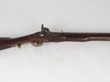 an old rifle with a wooden barrel on a white surface