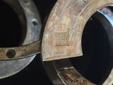 a close up of a metal object on a black surface