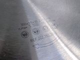 a close up of a metal cutting board with holes in it