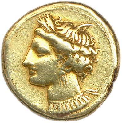 a close up of a gold coin with a woman ' s face on it