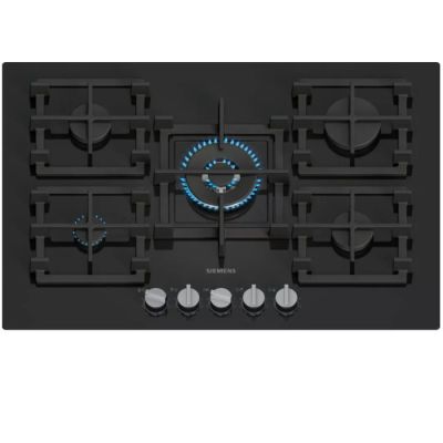 un gros plan d'une plaque de cuisson noire sur laquelle brille une lumière bleue