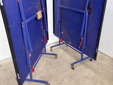 pair of blue steel frames with wheels on them in a room