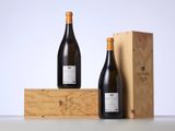 two bottles of wine sitting next to a wooden box