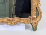 a mirror that is sitting on a table in front of a cabinet