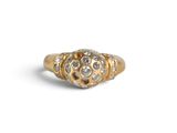 a close up of a gold and diamond ring on a white background