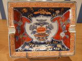 a red and blue plate with a picture of a bird on it