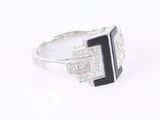 a close up of a ring with a black and white stone