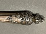 a silver spoon with a handle on a table