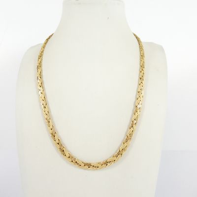 a close up of a gold necklace on a mannequin mannequin